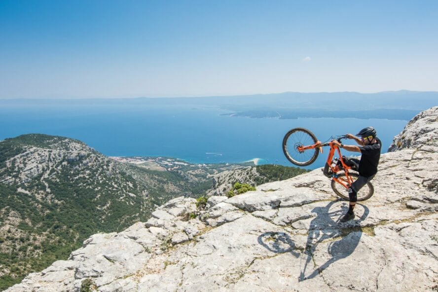 A mountain biker celebrates his summit of Vidova Gora on the island of Brač.