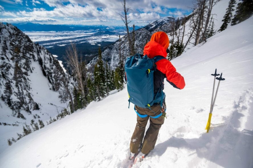 Backcountry skier skinning up a steep slope