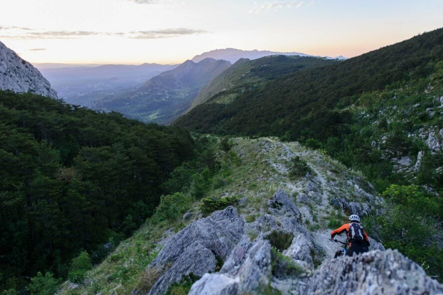 A mountain biker descends a steep ridge in Omiš.