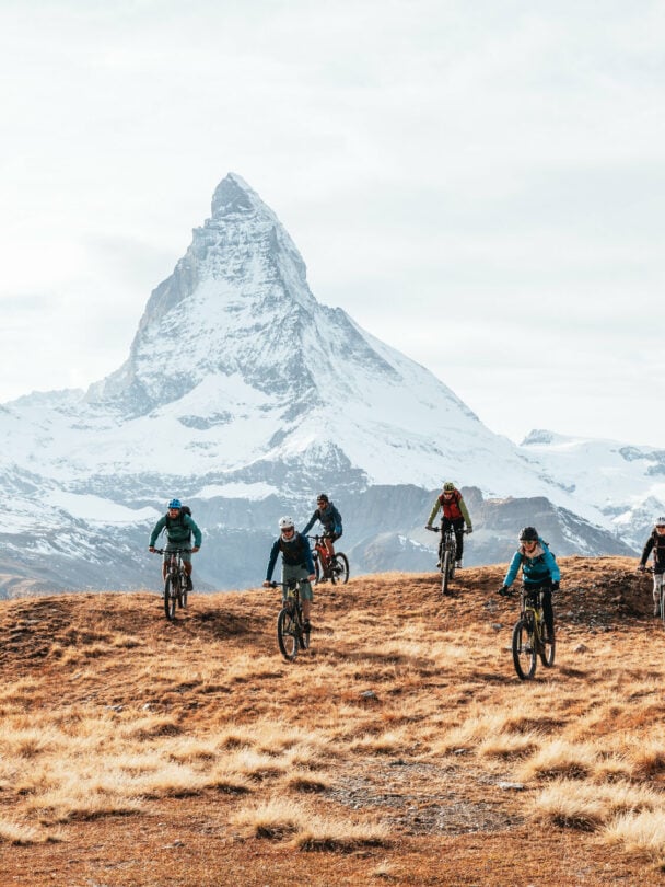 E-mountain bikers near Matterhorn, Swiss Alps.