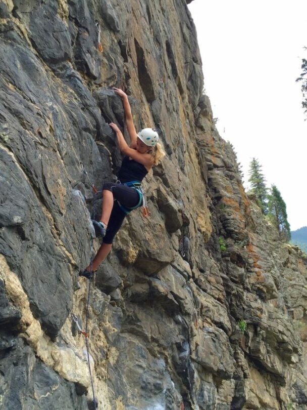 A woman climbing a cliff in Colorado